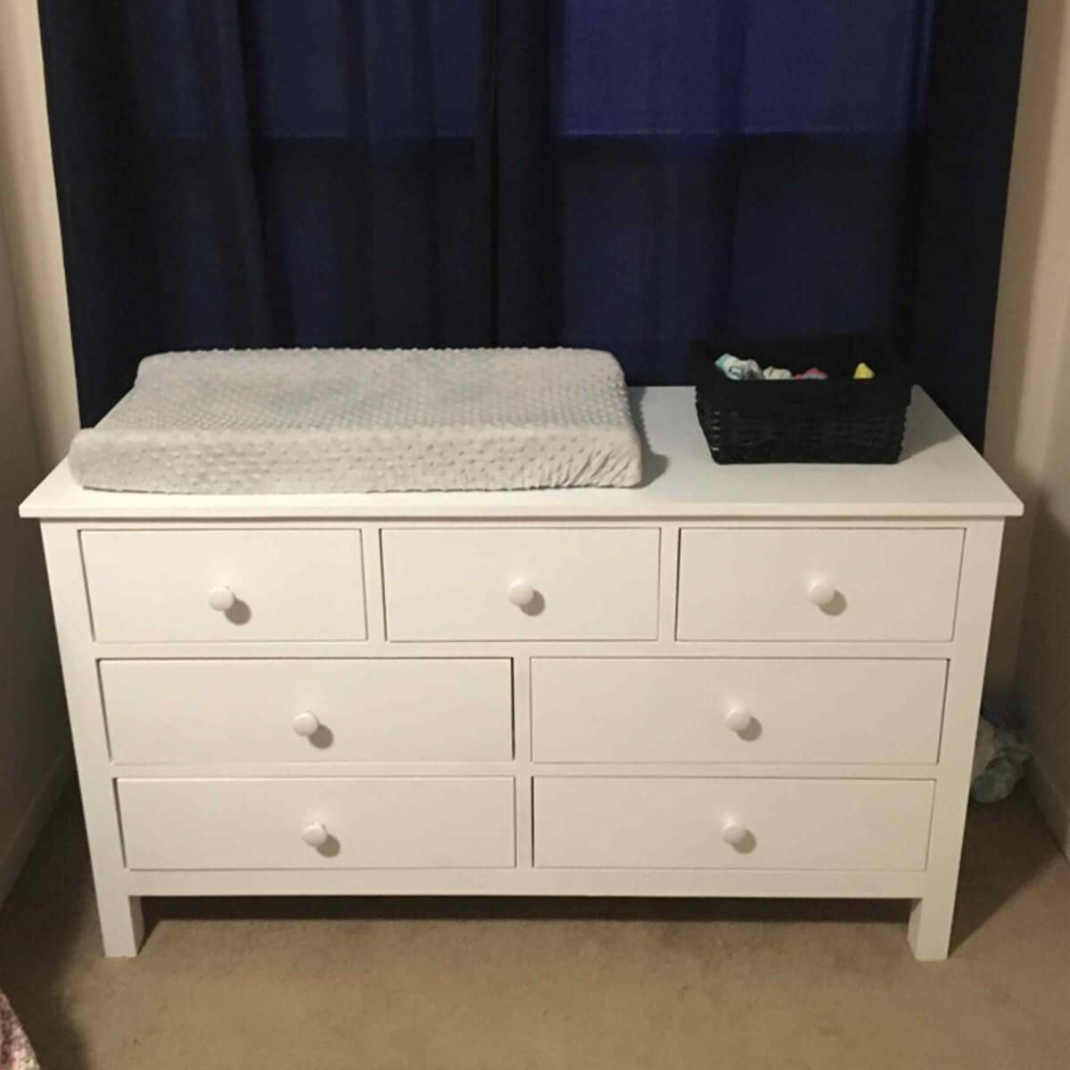 White painted wooden dresser with wood-topped surface