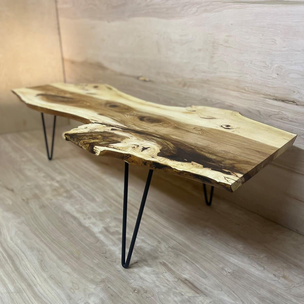 Live-edge wood coffee table on black hairpin legs